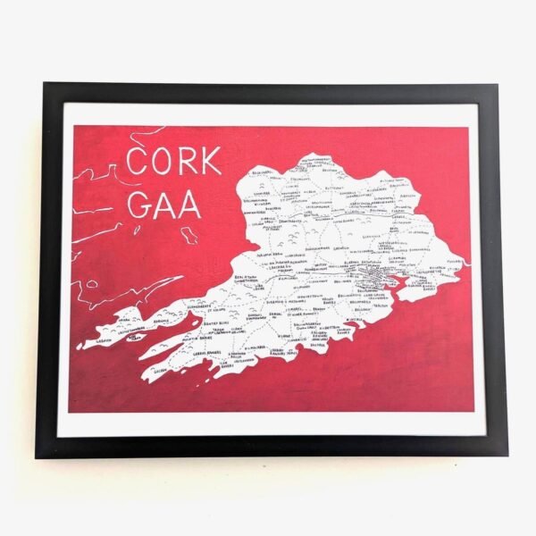 Framed map of Cork GAA on a red background with white lettering and detailed location names, conveying a sense of regional pride and history.