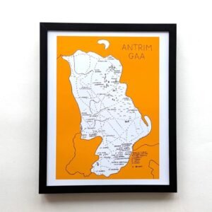 Framed map of Antrim GAA with intricate typography on a yellow background. The map's artistic design and vibrant color evoke a sense of culture and sports pride.