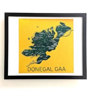 Framed artwork of a stylized Donegal map on a mustard background. The map features white text and is labelled "DONEGAL GAA" at the bottom.