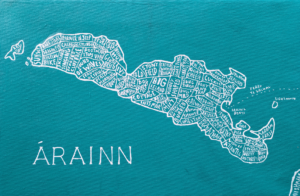 A hand painted map of Inishmore. It consists or white lettering marking various features of the island on a turquoise background. The map has Arainn written in large capital letters in the bottom left hand corner.