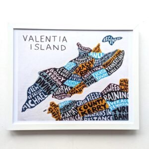 Framed artwork of Valentia Island. Island shape filled with colorful words; vibrant tones emphasize local landmarks and scenery. Mood is artistic and playful.
