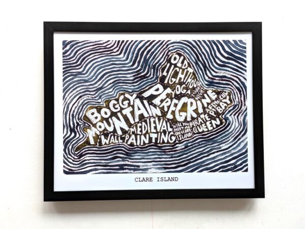 Framed artwork of Clare Island features bold text in island shape with words like "Boggy Mountains" and "Old Lighthouse" amid wavy line patterns.