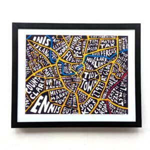 Framed map of Ennis, Ireland, with hand-drawn, colourful sections labelled with local landmarks and phrases, creating a vibrant, artistic vibe.