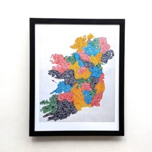Framed map of Ireland with colorful regions and text. The vibrant hues include red, yellow, blue, green, and black, creating a lively, artistic feel.