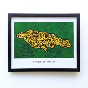 Framed artwork of Jamaica's map with names of traditional foods. Yellow map on green background. Caption reads "A Taste of Jamaica."