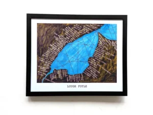 Framed artwork of Lough Foyle, featuring a blue geometric design representing the water, surrounded by brown land with handwritten place names. The text "Lough Foyle" is centered below.