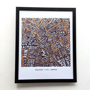 Framed artwork depicting a map of Belfast City Centre. Streets are creatively labelled with white text on an orange background, forming a complex pattern.