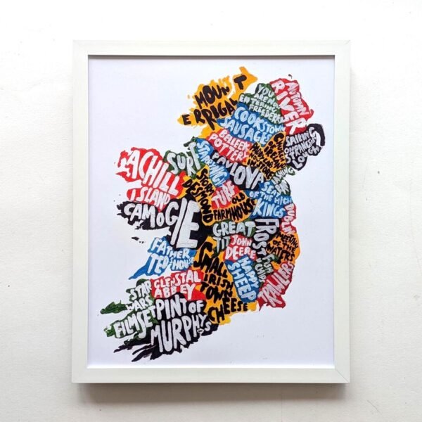 Framed artwork of Ireland's outline with colorful words like "Achill," "Murphy's," and "Abbey." The vibrant design highlights cultural elements.