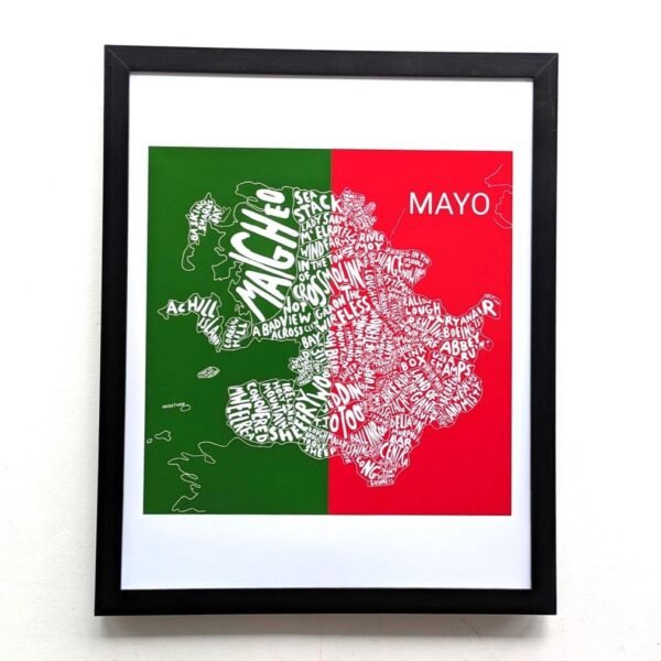 Framed artwork depicting a map of Mayo, Ireland, split in green and red. Town names form the map's shape, creating a lively and artistic tone.