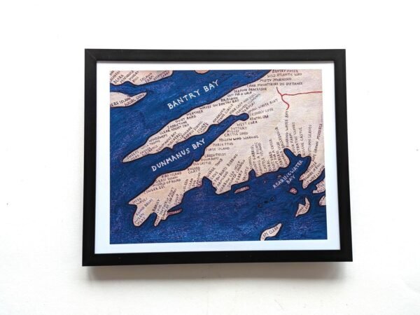 Framed nautical map art displaying Bantry Bay and Dunmanus Bay with detailed labels and deep blue ocean tones, set against a plain backdrop.