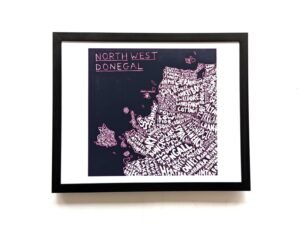Framed map art of Northwest Donegal with handwritten town names in white against a black background, conveying a creative and vibrant tone.