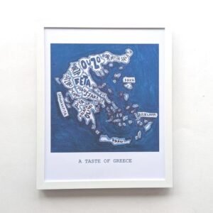 Framed artwork depicting a blue map of Greece labelled with Greek foods like "Feta" and "Baklava." Below, the text reads "A Taste of Greece."