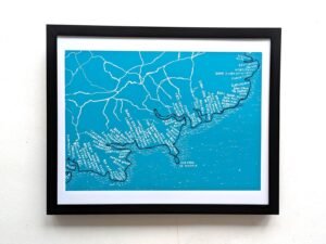 A framed map of west Cork on a teal background. White lines and labels show geographical details and place names, creating a detailed, artistic look.