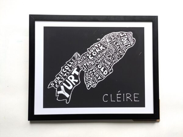 Framed artwork depicting an island map with place names in white on black, labeled “Cléire.” The tone is artistic and geographic. Keywords: map, island, art.