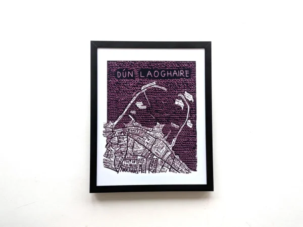 Framed artwork of Dún Laoghaire features a detailed street map with names in white on a dark purple background, conveying a modern, artistic vibe.