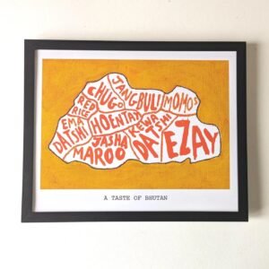 Framed artwork titled "A Taste of Bhutan" shows the country's shape filled with names of Bhutanese dishes in red and white, on a mustard background.