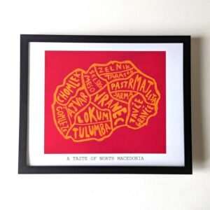 Framed artwork titled "A Taste of North Macedonia" features a red map with yellow outlines and names of local dishes, conveying cultural richness.