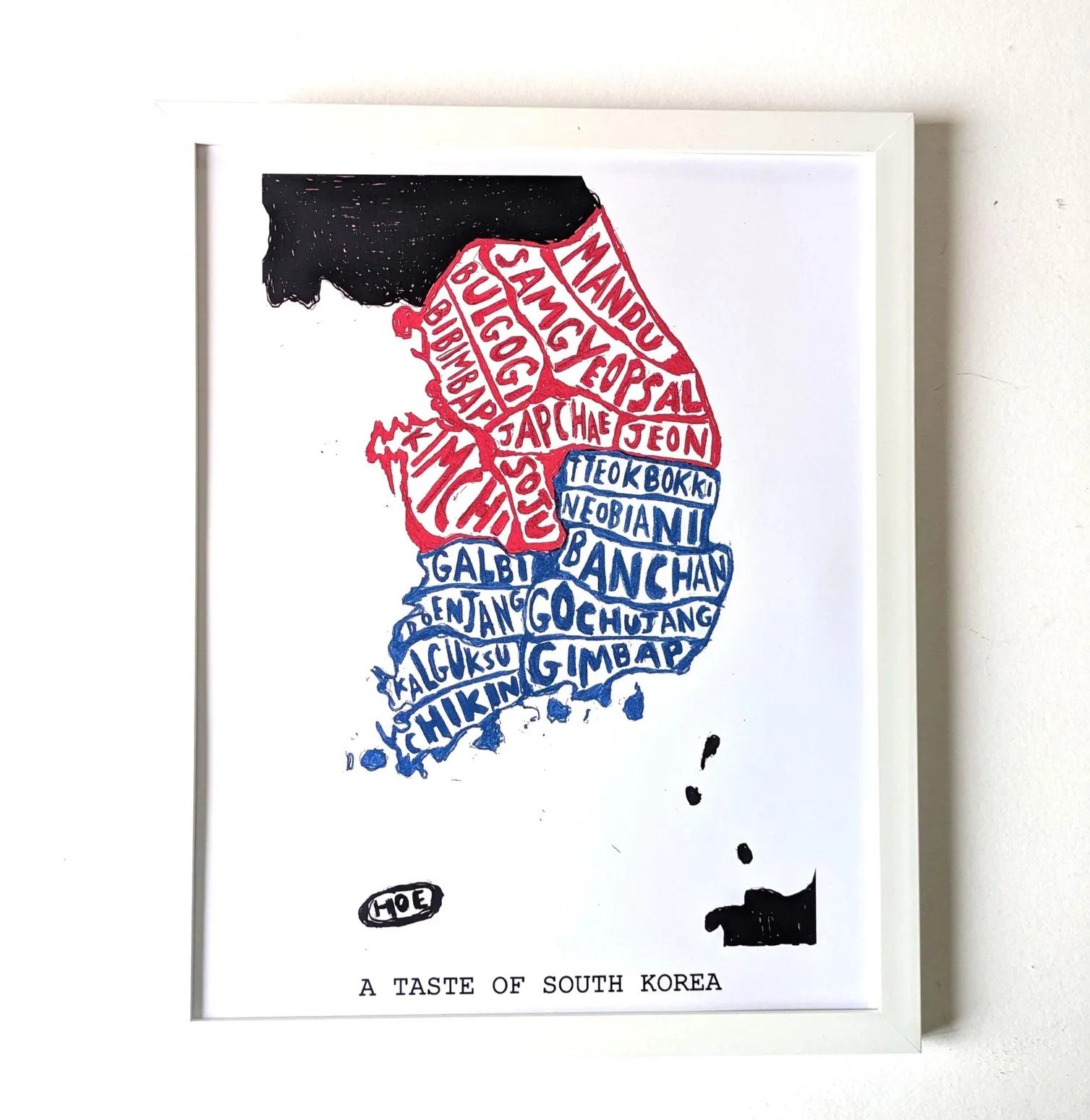 Framed artwork of South Korea's map depicted with food names in red and blue, titled "A Taste of South Korea." Energetic and cultural tone.