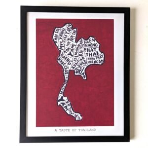 Framed artwork of Thailand's map with food names forming its shape on a red background. Text below reads "A Taste of Thailand." Bold and artistic.