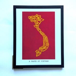 Framed artwork featuring a yellow outline of Vietnam on a red background, filled with names of Vietnamese dishes. Text reads "A Taste of Vietnam."